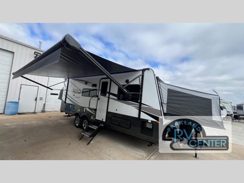 Forest River RV Rockwood Roo 233S expandable set up on the lot with the awning out and the expandable